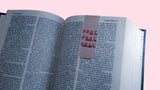 Open book with a pink bookmark with quote "Pray on it, Pray over it, Pray through it" on a pink background