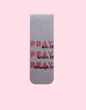 Pink magnetic bookmark with 'Pray on it, Pray over it, Pray through it' text on a pink background