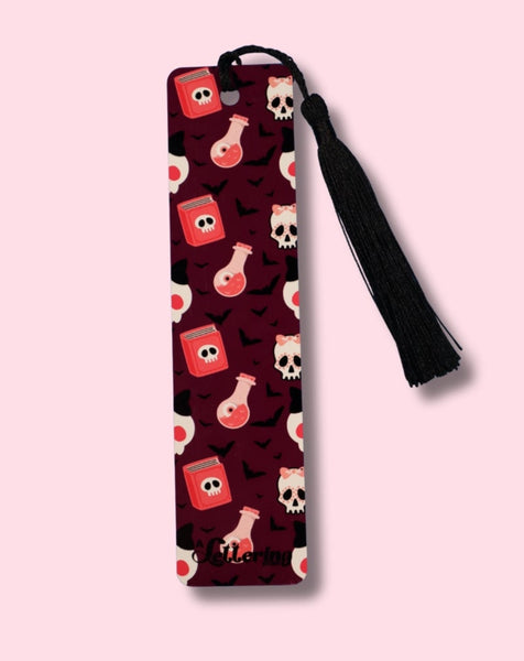Patterned bookmark with a black tassel on a pink background