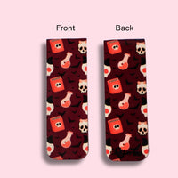 front and back view of a magnetic bookmark with potion bottles and skull pattern on a pink background