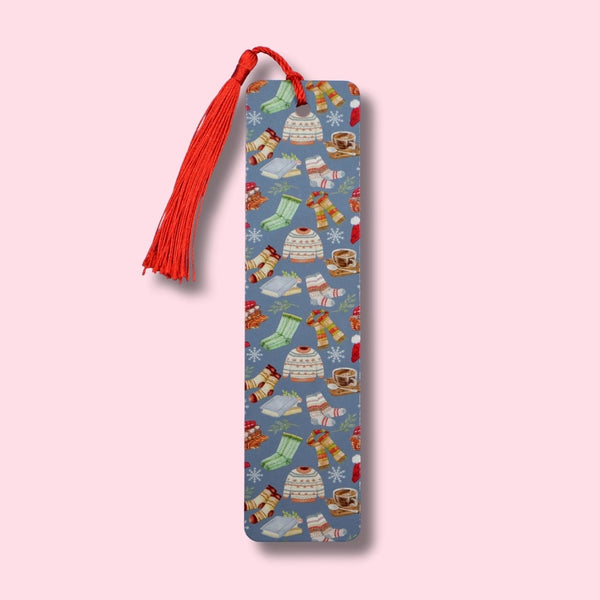 Decorative bookmark with sweaters and fuzzy socks on a pink background