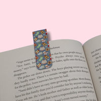 Winter-themed bookmark on an open book with a pink background