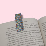 Winter-themed bookmark on an open book with a pink background