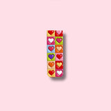 Rectangular magnetic bookmark with colorful heart-shaped candies on a pink background